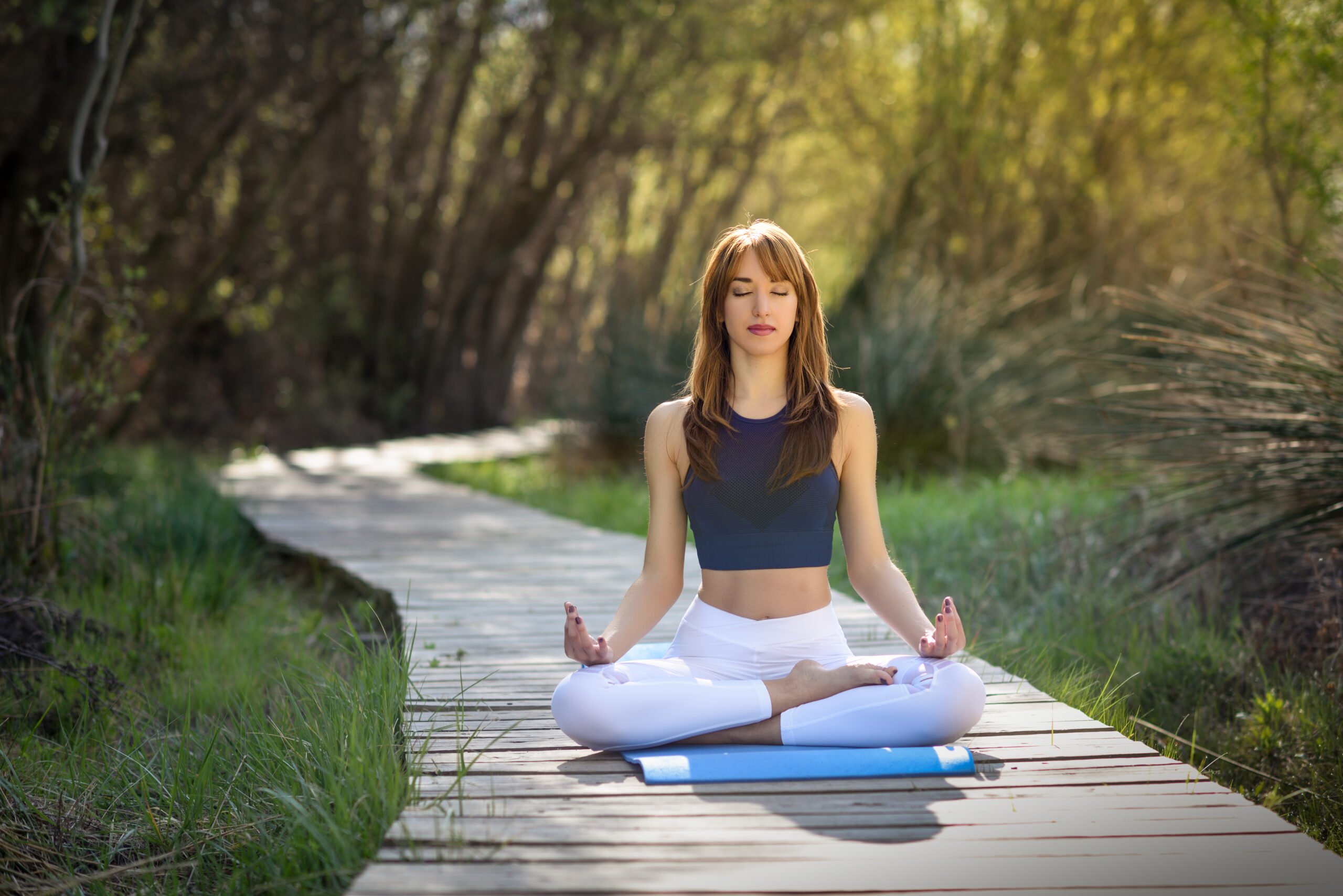 Home young beautiful woman doing yoga in nature